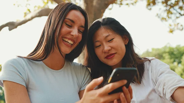 Young Multi Ethnic Smiling Women Watching Videos Phone Girls Laugh — Zdjęcie stockowe