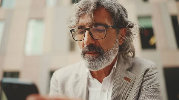 Mature Businessman Beard Eyeglasses Wearing Gray Jacket Holds Cellphone His — Fotografia de Stock