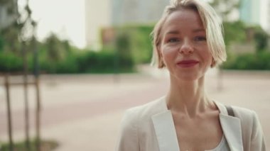 Close up, businesswoman crosses her arms, looks at the camera