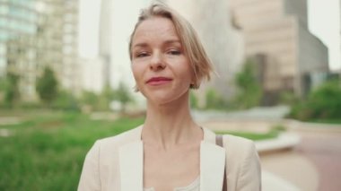 Close up, business woman looks at the camera