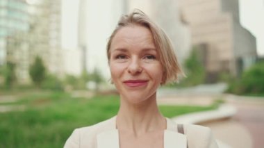 Close up, business woman looks at the camera