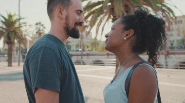 Close up, happy interracial family kisses outside