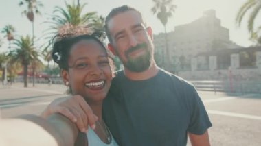 Close-up of interracial smiling couple in love taking selfie