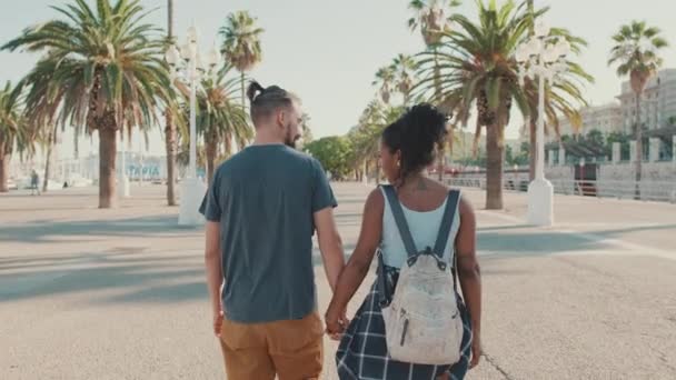 Interracial Couple Walks Street Holding Hands Back View — 图库视频影像