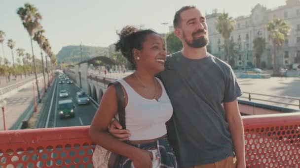Happy Interracial Couple Talking While Standing Bridge — стоковое видео