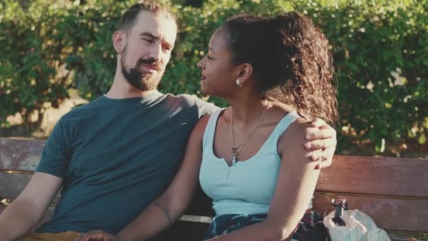 Interracial Couple Talking While Sitting Bench Hugging Kissing — Stock videók