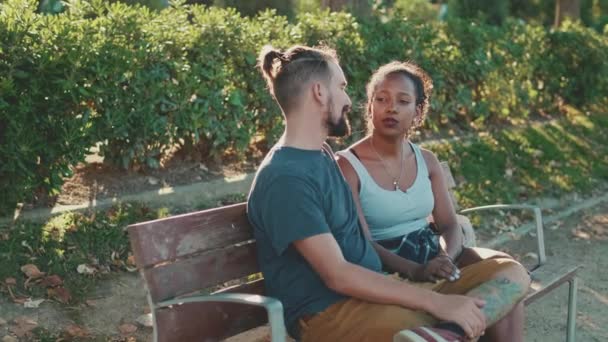 Interracial Couple Talking While Sitting Bench Backlight — Stock videók