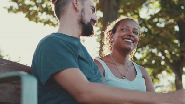Happy Smiling Interracial Couple Talking While Sitting Bench — Video Stock