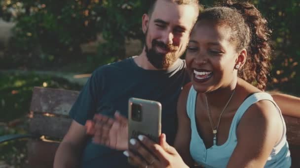 Happy Smiling Interracial Couple Making Video Call Cellphone While Sitting — Stockvideo