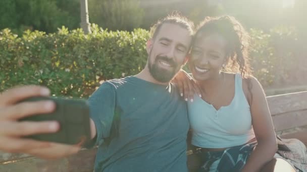 Happy Smiling Interracial Couple Taking Selfie Phone While Sitting Park — Stock videók