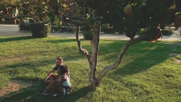 Loving Interracial Couple Holding Hands While Sitting Grass Lawn — Stockvideo