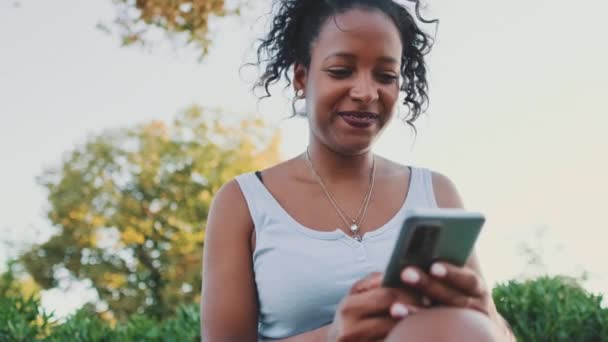 Young Mixed Race Woman Sits Park Bench Uses Cellphone — Stock videók