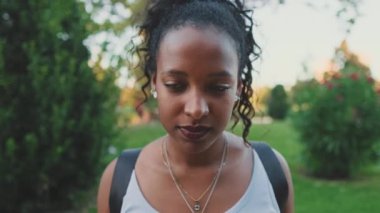 Close-up of smiling young mixed race woman looking at camera