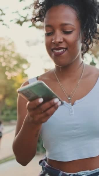 Vertical Video Smiling Young Mixed Race Woman Walks Path Park — Stock videók