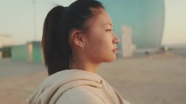 Close up, asian girl in sportswear doing workout, stretching at morning time