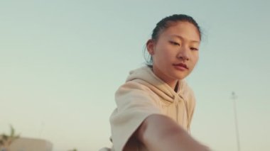 Asian girl in sportswear doing workout, stretching at morning time