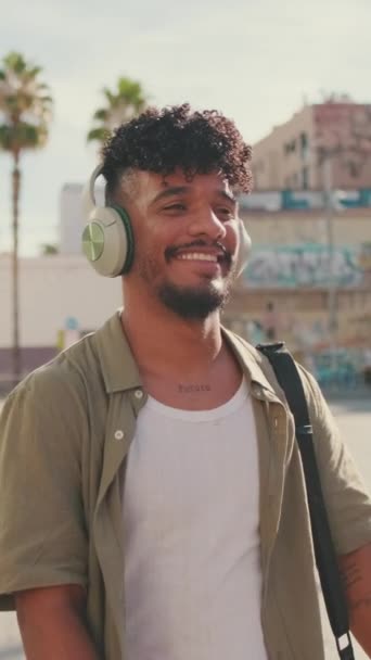 Vertical Video Young Man Beard Olive Colored Shirt Listens Music — Vídeos de Stock