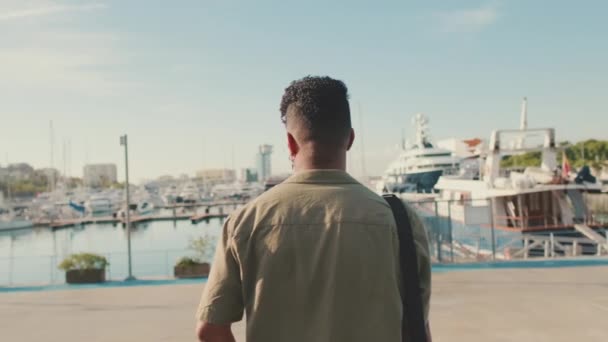 Young Man Dressed Olive Colored Shirt Standing Port Looking Yachts — Videoclip de stoc