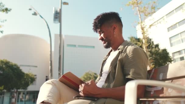 Young Male Student Wearing Olive Colored Shirt Takes Notes Notebook — Vídeo de stock