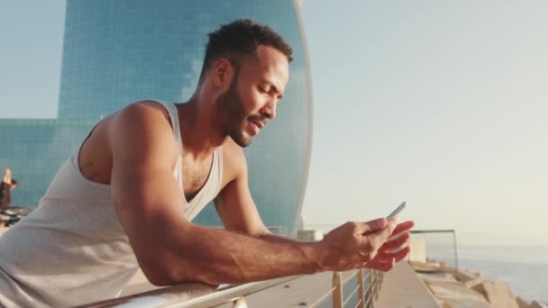 Young Bearded Male Fit Athletes Use Phone While Relaxing Workout — Αρχείο Βίντεο