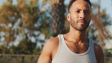 Close up, young bearded male fit athlete walks after training