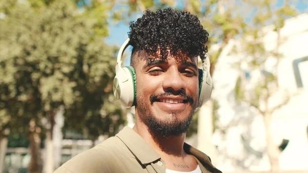 Close Young Man Headphones Turns His Head Looks Camera Smiles — Stockfoto
