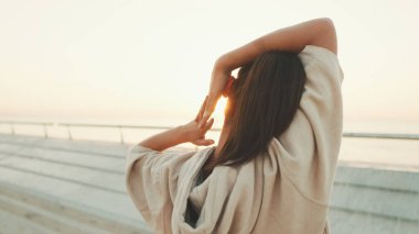 Asian girl in sportswear doing workout at morning time, stretching on modern buildings background