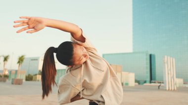 Asian girl in sportswear doing workout at morning time, stretching on modern buildings background