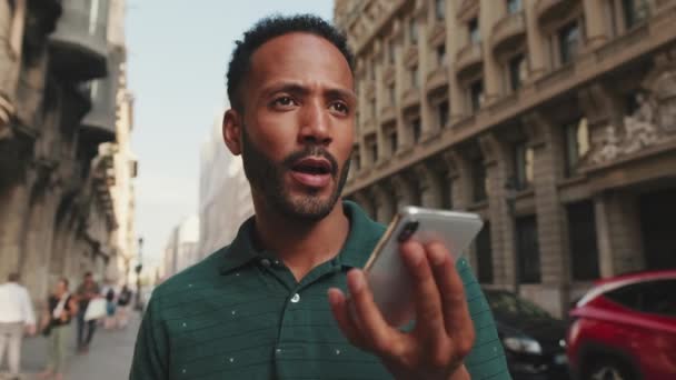 Молодой Человек Посылает Голосовое Сообщение Мобильный Телефон Стоя Улице Рядом — стоковое видео