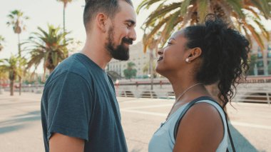 Happy interracial couple looking at each other