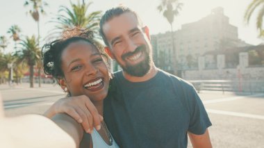 Close-up of interracial smiling couple in love taking selfie