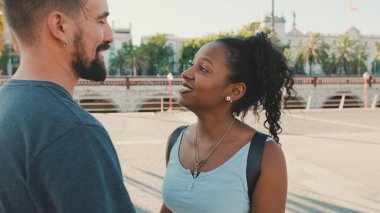 Happy interracial couple looking at each other