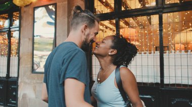 Happy interracial couple dancing outdoors
