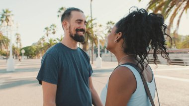 Happy interracial couple looking at each other