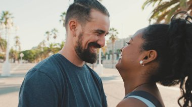 Happy interracial couple looking at each other