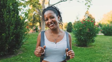 Close-up of smiling young mixed race woman looking at camera