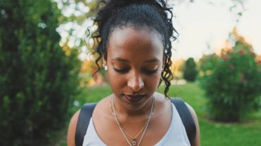 Close-up of smiling young mixed race woman looking at camera