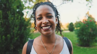 Close-up of smiling young mixed race woman looking at camera