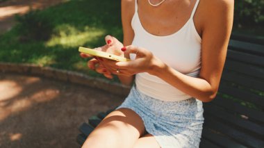 Close-up of young woman's hands using cellphone