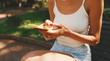 Close-up of young woman's hands using cellphone