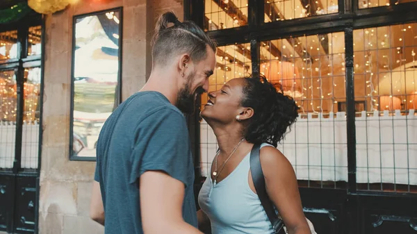 Happy interracial couple dancing outdoors