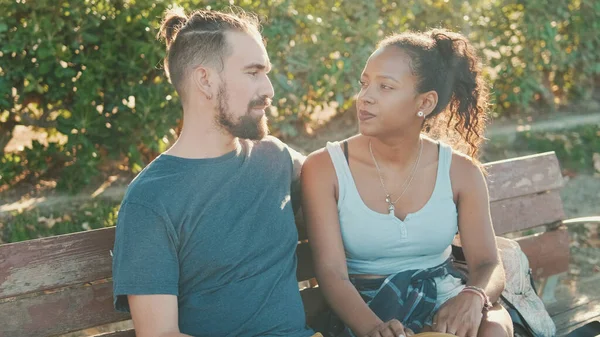 Interracial Couple Talking While Sitting Bench Backlight — Stok fotoğraf
