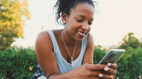 Laughing Young Mixed Race Woman Sitting Park Bench Using Cellphone — Foto de Stock