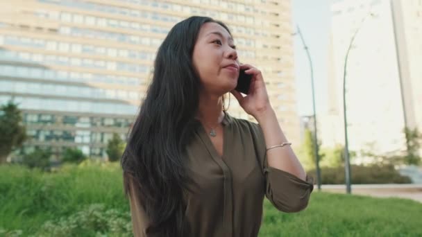 Modern Binalarda Otururken Akıllı Telefondan Konuşan Gülümseyen Genç Kız — Stok video