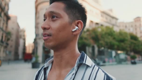 관광객들 광장을 산책하며 헤드셋으로 휴대폰 통화를 — 비디오