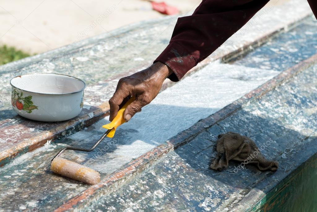 Boat varnish coating roller in hand. Stock Photo by ©big_tiger 21308817