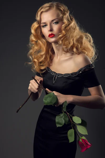 Beautiful girl in black dress with broken rose — Stock Photo, Image