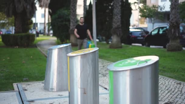 Szakállas férfi sétál hulladékválogató kukák kidobni szemetet újrahasznosítás. — Stock videók