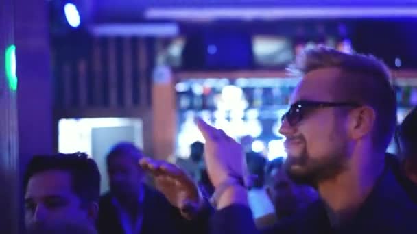 Casual stijlvolle hipster man met baard in bril dansen op nachtclub feest. — Stockvideo