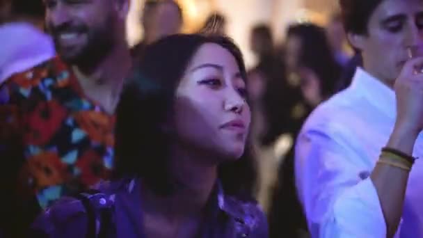 Lovely Asian lady of Chinese or Korean origin dances in crowd of party people. — Stock Video